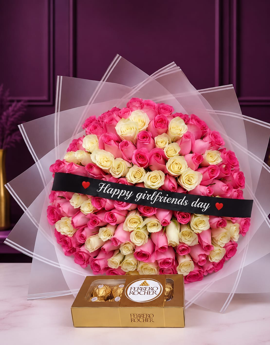 100 premium pink and white roses in sheer wrap with Happy Girlfriend's Day black sash and Ferrero Rocher chocolates on purple background